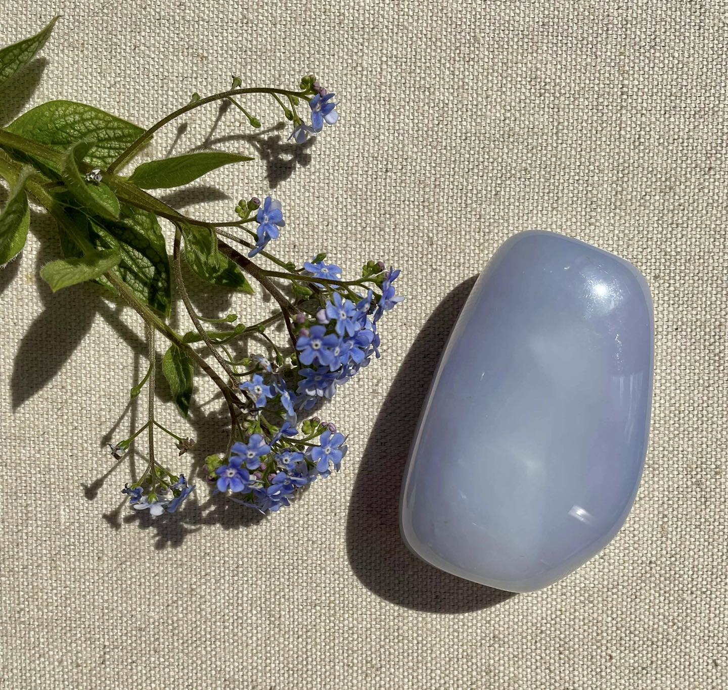 Photo of a gemstone with fresh flowers.